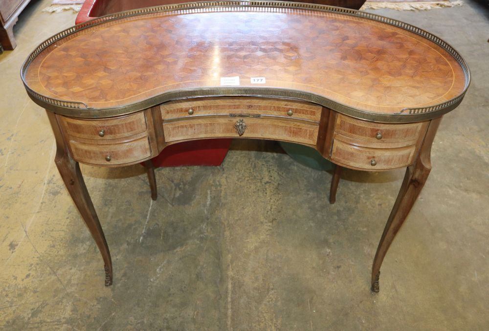 A Louis XVI design ormolu mounted parquetry inlaid kidney shaped writing desk, W.99cm